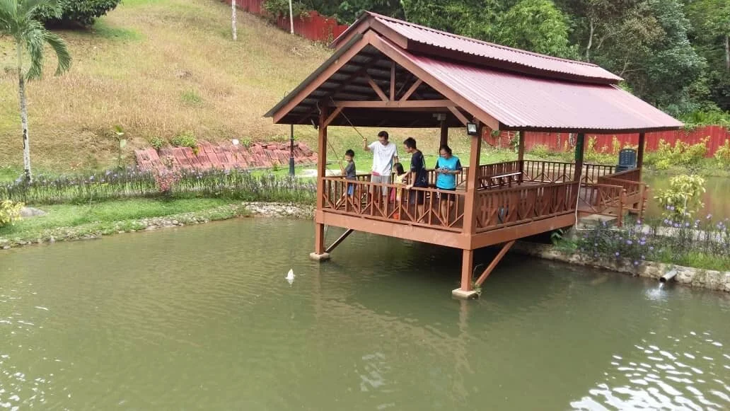 Wooden fish house on stilts over the pond