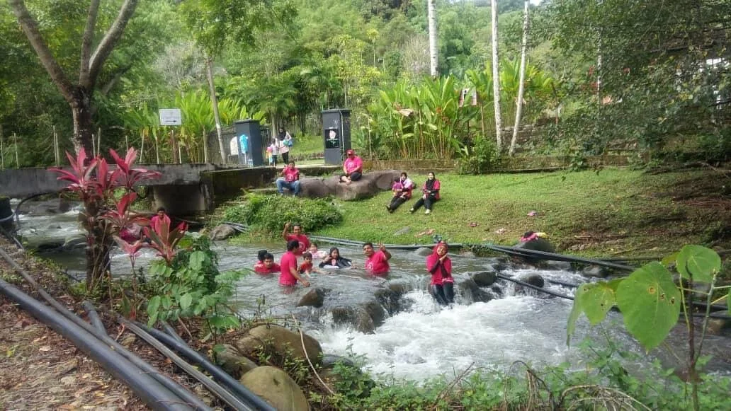 Children playing in the shallow, rocky river